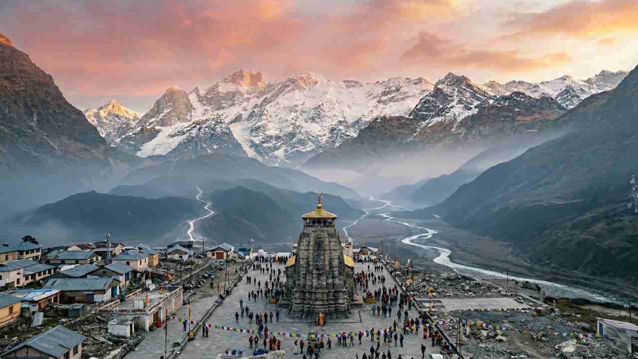 Aerial view of Kedarnath Temple at sunrise surrounded by snow-capped Himalayan peaks and Mandakini River valley
