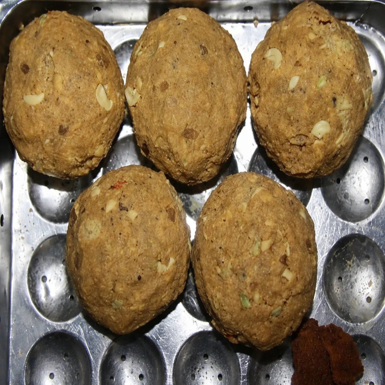 Famous Tirupati laddu prasadam served after Balaji Temple darshan.